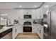 Modern white kitchen with stainless steel appliances, sleek countertops, and ample cabinet space at 5466 Silverheart Ave, Las Vegas, NV 89142