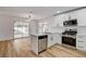 Bright kitchen with stainless appliances, a breakfast bar, and sliding doors to the backyard at 5466 Silverheart Ave, Las Vegas, NV 89142