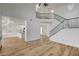 Spacious living room features a view into the modern kitchen and elegant staircase at 5466 Silverheart Ave, Las Vegas, NV 89142
