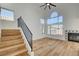 Bright living room with large windows, fireplace, and wood stairs with black metal railing at 5466 Silverheart Ave, Las Vegas, NV 89142