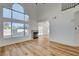 Bright living room showcasing a fireplace, large windows, and wood flooring at 5466 Silverheart Ave, Las Vegas, NV 89142