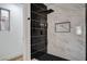 Modern walk-in shower boasts black and marble style tile, creating a spa-like experience at 5466 Silverheart Ave, Las Vegas, NV 89142