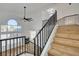 Staircase with wooden steps and black metal railing in a bright, open space at 5466 Silverheart Ave, Las Vegas, NV 89142