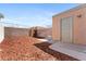 Cozy backyard features a wood fence, privacy wall, mulch, and access door at 5939 Vegas Dr, Las Vegas, NV 89108