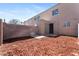 Spacious backyard with a privacy wall, mulch, and access door at 5939 Vegas Dr, Las Vegas, NV 89108
