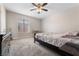 Cozy bedroom featuring plush carpet, a ceiling fan, and a window for natural light at 5939 Vegas Dr, Las Vegas, NV 89108