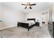 This carpeted bedroom offers a ceiling fan and a glimpse into the next room at 5939 Vegas Dr, Las Vegas, NV 89108