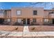 Charming townhome featuring a light peach exterior, dual black doors, and easy to maintain desert landscaping at 5939 Vegas Dr, Las Vegas, NV 89108