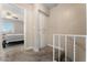 Hallway leading to a bedroom showcasing a ceiling fan, window, and comfortable bedding at 5939 Vegas Dr, Las Vegas, NV 89108