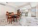 Eat-in kitchen features marble tile floor, white cabinetry, stainless steel appliances, and backyard access at 5939 Vegas Dr, Las Vegas, NV 89108