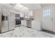 Bright eat-in kitchen featuring stainless steel appliances, white cabinets, granite counters and access to the backyard at 5939 Vegas Dr, Las Vegas, NV 89108
