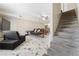 View of the living room and stairs featuring marble floors, comfortable seating, and backyard access at 5939 Vegas Dr, Las Vegas, NV 89108