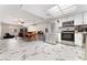 A spacious living area with modern marble flooring, updated stainless steel appliances and natural lighting at 5939 Vegas Dr, Las Vegas, NV 89108
