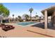 Community pool area with mature trees, picnic tables, and a secured fence at 5939 Vegas Dr, Las Vegas, NV 89108