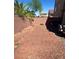 View of backyard with stone ground covering and brick perimeter at 6142 Kelson Creek Ct, Las Vegas, NV 89118