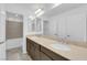 Bathroom featuring double sinks, quartz countertops, modern fixtures and tiled shower at 6142 Kelson Creek Ct, Las Vegas, NV 89118