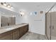 Primary bathroom with double sinks, quartz countertops, and walk-in shower at 6142 Kelson Creek Ct, Las Vegas, NV 89118