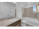 Modern bathroom features stylish tile, vanity, and a soaking tub for a relaxing experience at 6142 Kelson Creek Ct, Las Vegas, NV 89118