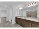 Bathroom with double sinks, quartz countertops, large mirror and walk-in shower at 6142 Kelson Creek Ct, Las Vegas, NV 89118