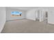 Bright bedroom with plush carpeting and a large window offering a neighborhood view at 6142 Kelson Creek Ct, Las Vegas, NV 89118