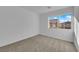 Cozy bedroom offers neutral plush carpet and a large window for ample sunlight at 6142 Kelson Creek Ct, Las Vegas, NV 89118