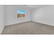 Well-lit bedroom with neutral carpet, white walls, and large window with neighborhood views at 6142 Kelson Creek Ct, Las Vegas, NV 89118
