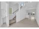 Bright entryway with tile flooring, stairs, and access to the living and powder room at 6142 Kelson Creek Ct, Las Vegas, NV 89118