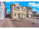 Inviting two-story home featuring a two-car garage and desert landscaping in front at 6142 Kelson Creek Ct, Las Vegas, NV 89118