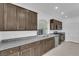 Modern kitchen with stainless steel appliances, dark cabinets, and granite countertops at 6142 Kelson Creek Ct, Las Vegas, NV 89118