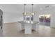 Bright kitchen features a large island with granite countertops and stainless steel refrigerator at 6142 Kelson Creek Ct, Las Vegas, NV 89118