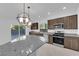 Modern kitchen with stainless steel appliances, dark cabinets, and granite countertops at 6142 Kelson Creek Ct, Las Vegas, NV 89118