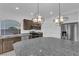 Modern kitchen with stainless steel appliances, dark cabinets, and granite countertops at 6142 Kelson Creek Ct, Las Vegas, NV 89118