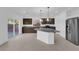Modern kitchen with stainless steel appliances, dark cabinets, and granite countertops at 6142 Kelson Creek Ct, Las Vegas, NV 89118