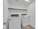 Modern laundry room featuring new appliances and a shelf perfect for organizing supplies at 6142 Kelson Creek Ct, Las Vegas, NV 89118