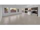 Bright and airy living room leading to a kitchen featuring tile floors and many windows at 6142 Kelson Creek Ct, Las Vegas, NV 89118