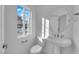 Modern powder room featuring a sleek pedestal sink and a large window at 6142 Kelson Creek Ct, Las Vegas, NV 89118