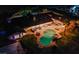 Aerial view of the property showcasing pool, outdoor seating, and lush landscaping at night at 6419 Eldora Ave, Las Vegas, NV 89146
