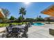 Inviting backyard featuring a pool, patio furniture, lush grass, and a tall palm tree at 6419 Eldora Ave, Las Vegas, NV 89146