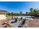 Charming backyard featuring a fire pit with seating, basketball court, and mature trees at 6419 Eldora Ave, Las Vegas, NV 89146
