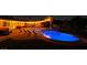 Sparkling swimming pool illuminated at night, surrounded by lounge chairs and inviting patio furniture at 6419 Eldora Ave, Las Vegas, NV 89146