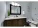 Bathroom featuring a wood vanity with quartz countertop and decorative accents at 6419 Eldora Ave, Las Vegas, NV 89146
