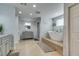 Spacious bathroom with double vanity, soaking tub, glass shower, and decorative hooks at 6419 Eldora Ave, Las Vegas, NV 89146