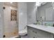 Bathroom featuring a walk-in shower with decorative tile, a modern vanity, and large mirror at 6419 Eldora Ave, Las Vegas, NV 89146