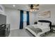 Cozy bedroom featuring a queen-sized bed, ceiling fan, and dresser with a television at 6419 Eldora Ave, Las Vegas, NV 89146
