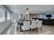 Open-concept dining room with a long table and ample seating, connecting to the living area at 6419 Eldora Ave, Las Vegas, NV 89146