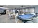 Spacious game room with poker table, ping pong table, and garage door entrance at 6419 Eldora Ave, Las Vegas, NV 89146
