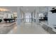 Expansive hallway with sleek tile flooring, columns, and views into multiple rooms at 6419 Eldora Ave, Las Vegas, NV 89146