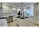A cozy kitchen features white cabinets and sleek countertops with a matching island at 6419 Eldora Ave, Las Vegas, NV 89146
