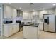 Updated kitchen featuring stainless steel appliances, island, and bright white cabinets at 6419 Eldora Ave, Las Vegas, NV 89146