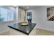Bright kitchen island featuring a black countertop and white cabinets, illuminated by natural light at 6419 Eldora Ave, Las Vegas, NV 89146